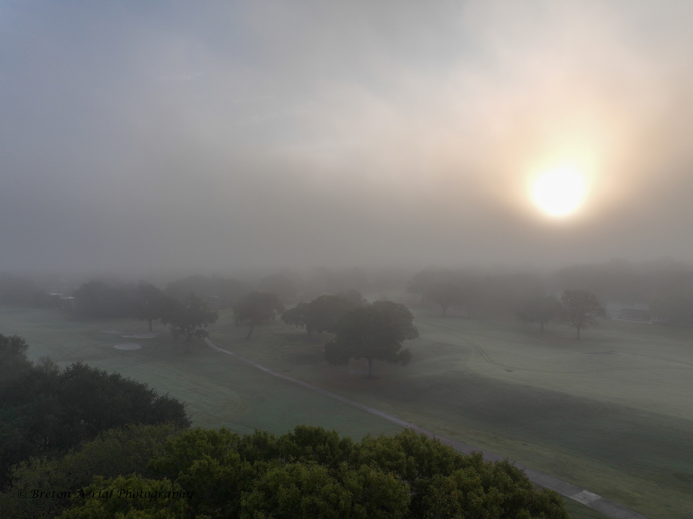 Sun rising through fog above Sugar Creek